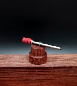This image portrays Dynavap Spinning Mouthpiece-Redheart Wood by Dovetail Woodwork.