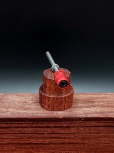 This image portrays Dynavap Spinning Mouthpiece-Redheart Wood by Dovetail Woodwork.