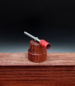 This image portrays Dynavap Spinning Mouthpiece-Redheart Wood by Dovetail Woodwork.