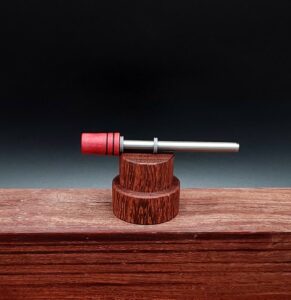 This image portrays Dynavap Spinning Mouthpiece-Redheart Wood by Dovetail Woodwork.