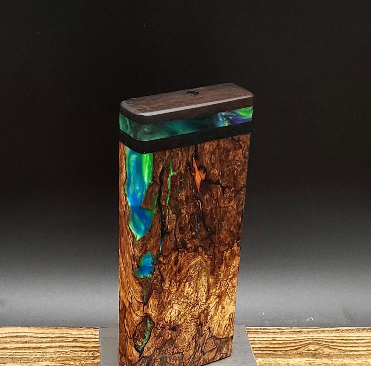This image portrays Luminescent Cosmic Burl-Dynavap Stash Case by Dovetail Woodwork.