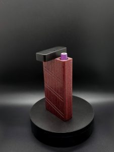 This image portrays 2G-XL Stash-Purpleheart/Ebony Wood-Dynavap Case by Dovetail Woodwork.