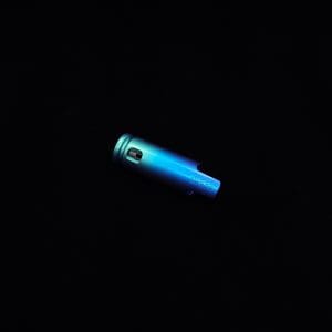 This image portrays The Dynavap Thermal Hyper Cap/Custom Anodized Green-Blue Fade by Dovetail Woodwork.