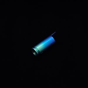 This image portrays The Dynavap Thermal Hyper Cap/Custom Anodized Green-Blue Fade by Dovetail Woodwork.