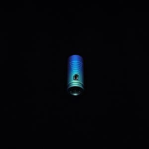 This image portrays The Dynavap Thermal Hyper Cap/Custom Anodized Green-Blue Fade by Dovetail Woodwork.